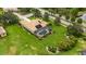 Beautiful property showcasing a tile roof, screened pool, and manicured yard with mature landscaping at 385 165Th Ne Ct, Bradenton, FL 34212