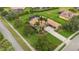 Aerial view of a home boasting well-kept landscaping, tile roof, and a long driveway, with palm trees at 385 165Th Ne Ct, Bradenton, FL 34212