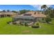 Aerial view of home with a screened pool, landscaping, and tile roof at 385 165Th Ne Ct, Bradenton, FL 34212