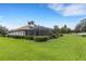 Spacious backyard featuring lush green grass, mature trees, and a screened-in pool area at 385 165Th Ne Ct, Bradenton, FL 34212