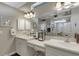 Bright bathroom featuring double sinks, vanity, large mirror, and walk-in shower at 385 165Th Ne Ct, Bradenton, FL 34212
