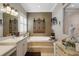 Well-appointed bathroom with dual sinks, soaking tub, and stylish decor creating a serene atmosphere at 385 165Th Ne Ct, Bradenton, FL 34212