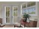 Cozy bedroom sitting area with French doors and windows, providing ample natural light and outdoor views at 385 165Th Ne Ct, Bradenton, FL 34212