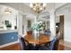 An inviting dining room with a round wood table, elegant chandelier, and arched doorways at 385 165Th Ne Ct, Bradenton, FL 34212