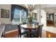 Dining area with hardwood floors, a round table and a large window with blue drapes at 385 165Th Ne Ct, Bradenton, FL 34212