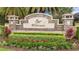 Stone entrance sign for Rye Wilderness community surrounded by colorful flowers and manicured shrubs at 385 165Th Ne Ct, Bradenton, FL 34212