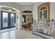 Welcoming foyer with decorative tile flooring, an arched doorway, and an accent table at 385 165Th Ne Ct, Bradenton, FL 34212
