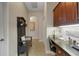 Hallway featuring a built-in desk, coat rack and tiled floor leading to other rooms at 385 165Th Ne Ct, Bradenton, FL 34212