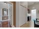Inviting hallway with wood and tile floors, showcasing closet and office space at 385 165Th Ne Ct, Bradenton, FL 34212