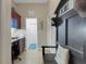 Hallway featuring a built-in desk, coat rack and tiled floor leading to other rooms at 385 165Th Ne Ct, Bradenton, FL 34212