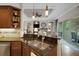 Gourmet kitchen featuring granite countertops, stainless appliances, and breakfast bar open to living area at 385 165Th Ne Ct, Bradenton, FL 34212