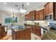 Modern kitchen featuring granite countertops, stainless steel appliances, and dark cabinets at 385 165Th Ne Ct, Bradenton, FL 34212