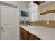 Convenient laundry room with ample counter space, cabinet storage, and decor at 385 165Th Ne Ct, Bradenton, FL 34212