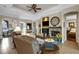 Comfortable living room with fireplace and large windows offers abundant natural light and ceiling fan at 385 165Th Ne Ct, Bradenton, FL 34212