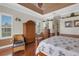 Charming main bedroom with hardwood floors, tray ceiling, ceiling fan, and elegant furnishings at 385 165Th Ne Ct, Bradenton, FL 34212