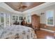 Spacious bedroom featuring hardwood floors, tray ceiling, ceiling fan, and ample natural light at 385 165Th Ne Ct, Bradenton, FL 34212