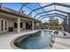 Enclosed pool with spa steps out to a covered back patio and views of the yard at 385 165Th Ne Ct, Bradenton, FL 34212
