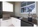 Outdoor summer kitchen with sink, grill, granite countertops, and plenty of storage at 385 165Th Ne Ct, Bradenton, FL 34212
