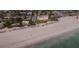 Beautiful aerial view of a beachfront property with a pristine sandy beach and turquoise waters at 4200 Gulf Dr # 104, Holmes Beach, FL 34217
