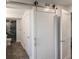 Modern bathroom featuring a stylish barn door, a sleek vanity, and a glass-enclosed shower with marble-like tile at 4200 Gulf Dr # 104, Holmes Beach, FL 34217