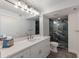 Contemporary bathroom with a marble-tiled shower, a white vanity, and modern lighting fixtures at 4200 Gulf Dr # 104, Holmes Beach, FL 34217