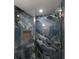 Luxurious bathroom shower featuring exquisite marble tile and a built-in niche at 4200 Gulf Dr # 104, Holmes Beach, FL 34217