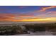 Scenic beach view at sunset featuring calm waters and colorful sky, framed by lush coastal vegetation at 4200 Gulf Dr # 104, Holmes Beach, FL 34217