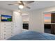 Beachside bedroom with a TV, a chest of drawers, and serene ocean views from two windows at 4200 Gulf Dr # 104, Holmes Beach, FL 34217