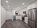 Modern kitchen featuring white cabinets, stainless steel appliances, and stone countertops with a grey tiled backsplash at 4200 Gulf Dr # 104, Holmes Beach, FL 34217
