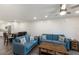 Spacious living area featuring stylish blue sofas, a dark wood coffee table, and a combined kitchen and dining space at 4200 Gulf Dr # 104, Holmes Beach, FL 34217
