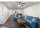 Open-concept living space with modern furnishings, including blue sofas and a dark wood coffee table, leading to the kitchen at 4200 Gulf Dr # 104, Holmes Beach, FL 34217