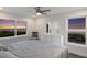Bright main bedroom features large windows with gorgeous ocean views, tile floors, and crisp white furniture at 4200 Gulf Dr # 104, Holmes Beach, FL 34217