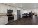 Open floorplan featuring the kitchen, dining area, and living room with beautiful luxury finishes and fixtures at 4200 Gulf Dr # 104, Holmes Beach, FL 34217