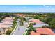 Aerial view of neighborhood showcasing mature landscaping, tile roofs, and manicured lawns at 4239 Corso Venetia Blvd, Venice, FL 34293