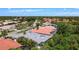 Stunning aerial view of community showcasing lush trees and well-maintained homes with beautiful rooftops at 4239 Corso Venetia Blvd, Venice, FL 34293