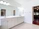 Spacious bathroom with double sinks, lots of storage, and tile flooring at 4239 Corso Venetia Blvd, Venice, FL 34293
