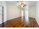 Bedroom features hardwood floors, a ceiling fan, and an exterior door to the patio at 4239 Corso Venetia Blvd, Venice, FL 34293