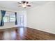 Bright and airy room boasting hardwood floors, a large window, and modern ceiling fan at 4239 Corso Venetia Blvd, Venice, FL 34293