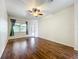 Bedroom features hardwood floors, a ceiling fan, and access to a private outdoor space at 4239 Corso Venetia Blvd, Venice, FL 34293