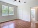Bedroom with a window offering natural light, laminate flooring, and a bathroom at 4239 Corso Venetia Blvd, Venice, FL 34293