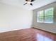 Bedroom with a window offering natural light and dark laminate flooring at 4239 Corso Venetia Blvd, Venice, FL 34293