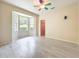 Sun-lit bedroom with new vinyl flooring, bay window, and a closet at 4239 Corso Venetia Blvd, Venice, FL 34293