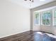 Bedroom features dark wood floors and large windows that bring in plenty of natural light at 4239 Corso Venetia Blvd, Venice, FL 34293