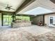 Covered patio with stone bar, ceiling fans, and outdoor seating at 4239 Corso Venetia Blvd, Venice, FL 34293