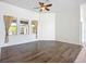 Bright den with hardwood floors, a ceiling fan, and windows overlooking the lanai at 4239 Corso Venetia Blvd, Venice, FL 34293
