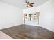 Cozy den with hardwood flooring, a ceiling fan, and bright windows with charming curtains at 4239 Corso Venetia Blvd, Venice, FL 34293