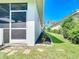 Wide shot of the landscaped side yard and screened in patio at 4239 Corso Venetia Blvd, Venice, FL 34293