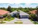 Beautiful home with a paver driveway, lush landscaping and a two-car garage at 4239 Corso Venetia Blvd, Venice, FL 34293