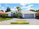 Lovely home with a paved driveway, palm trees, an attached two-car garage and manicured lawn at 4239 Corso Venetia Blvd, Venice, FL 34293