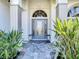 Elegant front entrance with a decorative glass door, sidelights and transom window at 4239 Corso Venetia Blvd, Venice, FL 34293